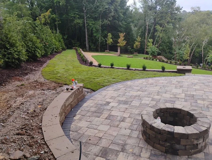Patio and fire pit area with grading and surrounding landscape work
