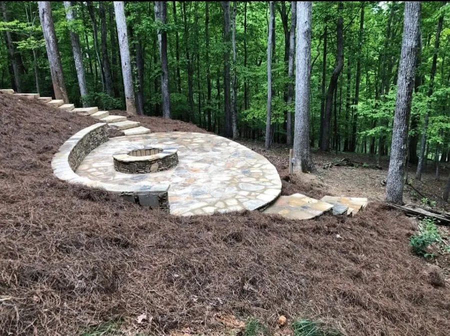 Flagstone patio and fire pit built into a wooded backyard
